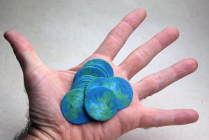 seeded paper globes in outstretched hand