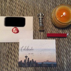 image of candle, wax seal and a card