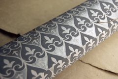 white with silver and grey handmade paper rolled